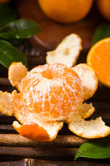 Fresh mandarin oranges or tangerines on wooden table.