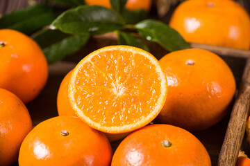 Fresh mandarin oranges or tangerines on wooden table.