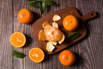 Fresh mandarin oranges or tangerines on wooden table.
