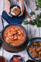 hand in frame eating, dishes on the table