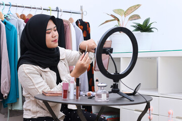 Muslim asian female beauty social media influencer livestream marketing cosmetics a make up...