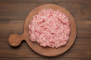 Raw fresh minced meat on wooden table, top view