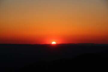 Sun halfway set over the horizon creating a nice orange sky.