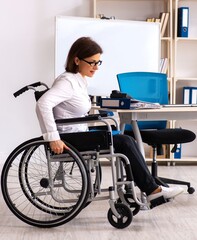 Obraz na płótnie Canvas Female employee in wheel-chair at the office