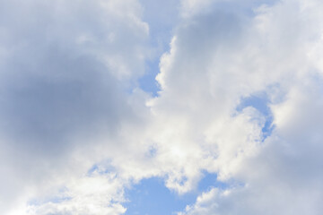 Blue sky with clouds in daylight symbolizing tranquility purity peaceful atmosphere sending a beautiful message from the heavens through nature and clouds during springtime with environmental beauty
