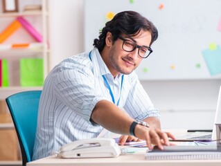 Young handsome male designer working in the office