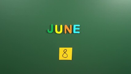 Hand sticking a sticker 8 June calendar day on school board. 8 date of June. Eighth day of June. 8th date number. 8 day calendar. Eight date. World Oceans, World Brain Tumor