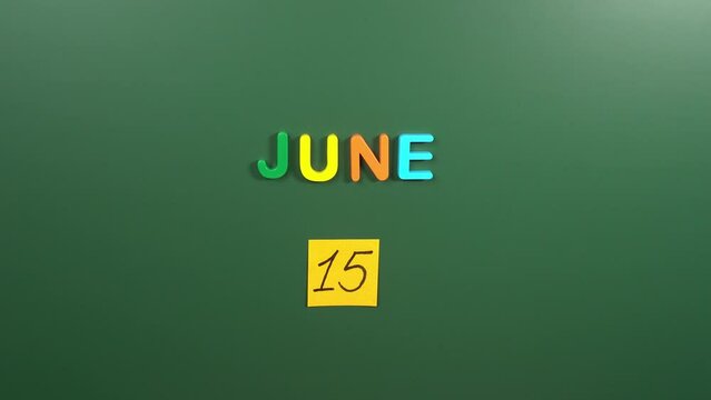 Hand sticking a sticker 15 June calendar day on school board. 15 date of June. Fifteenth day of June. 15th date number. 15 day calendar. Fifteen date. World Elder abuse awareness, National Bug Busting