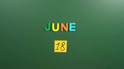 Hand sticking a sticker 18 June calendar day on school board. 18 date of June. Eighteenth day of June. 18th date number. 18 day calendar. Eighteen date. Happy Fathers, Autistic Pride, Sustainable