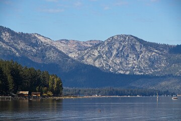 Parasailers and boaters begin their mornings on the peaceful waters of Lake Tahoe in the Sierra Nevada Mountains.