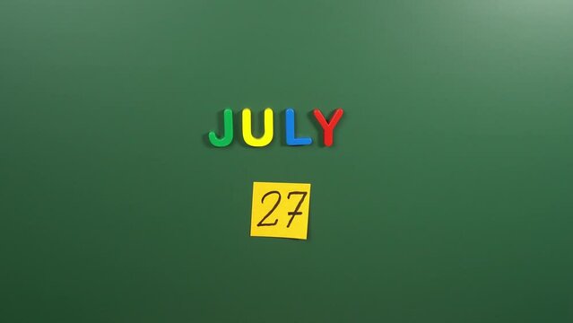 Hand Sticking A Sticker 27 July Calendar Day On School Board. 27 Date Of July. Twenty Seventh Day Of July. 27th Date Number. 27 Day Calendar. Twenty Seven Date. Korean War Veterans, Chicken Finger