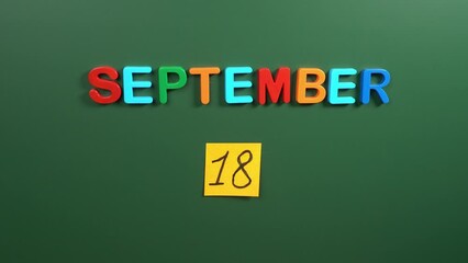 Hand sticking a sticker 18 September calendar day on school board. 18 date of September. Eighteenth day of September. 18th date number. 18 day calendar. Eighteen date. Chile independence day