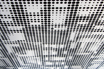 Metal ceiling. Perforated panels of suspended ceiling. Office building interior fragment. Abstract...