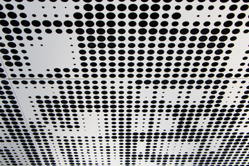 Metal ceiling strong durable. Perforated panels of suspended ceiling. Office building interior fragment. Abstract background textures on subject of modern architecture or construction industry.