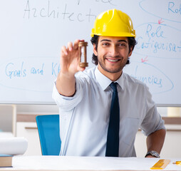 Young male architect in front of the whiteboard