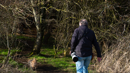 nature photographer. Nature photographer walking in nature with his dogs and taking nature photos