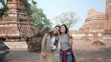 Happy, Two Asian women are cheerful in the old town. Phra Nakhon Si Ayutthaya, Thailand. Traveling on holidays