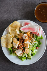 tahu goreng , Indonesian salad is mixed vegetables and tofu, peanut,crackers served with sweet and...
