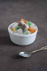 bubur chacha, coconut  milk sweet dessert with taro, sweet potato, palm seed, jelly tapioca. Indonesia dessert