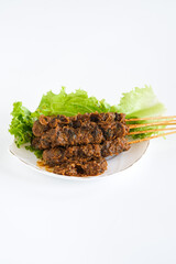 sate kerang, shell satay made from shell with spices like rendang. selective focus