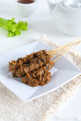 sate kerang, shell satay made from shell with spices like rendang. selective focus