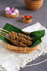sate kerang, shell satay made from shell with spices like rendang. selective focus