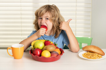 Child eats strawberry, organic fruits. Child boy eating organic healthy food. Healthy vegetables...
