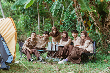 Fototapeta na wymiar group of young scouts smiling at the camera while gathering in nature