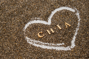 Heart made of chia seeds with word CHIA inside background. Healthy superfood rich in Omega 3 fatty acids. Dry healthy natural ingredient. Vegetarian food favorite dietary products