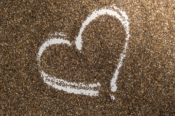 Heart made of chia seeds background. Healthy superfood rich in Omega 3 fatty acids. Dry healthy natural ingredient. Vegetarian food favorite dietary products