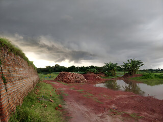 A brick wall borders the tranquil pond, providing a sturdy barrier between the water and the surrounding landscape.