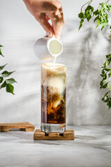 iced coffee and milk on a white table