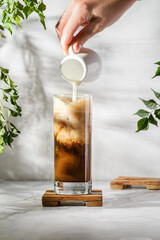 iced coffee and milk on a white table