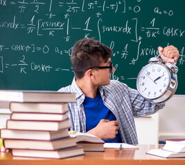 Young male student studying math at school