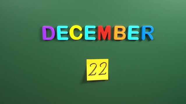 Hand sticking a sticker 22 December calendar day on school board. 22 date of December. Twenty second day of December. 22th date number. 22 day calendar. Twenty two date. Mathematics