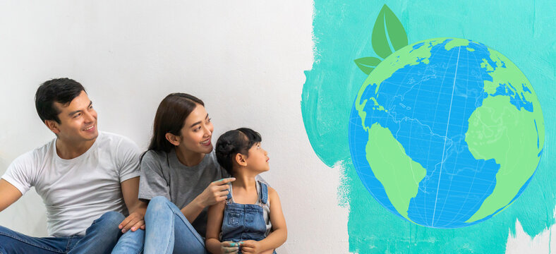 Portrait of asian family father and mother with little girl look at paint saving clean energy earth globe world environment green eco friendly.campaign save the earth and earth Day 22 April