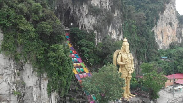 Lord Murugan statue with a colorful staircase leading to the Batu Caves