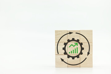 Gear and graph up icons on wooden block cubes on white background.Continuous improvement concept....