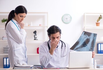 Two young doctors working in the clinic