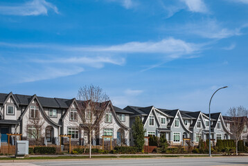 Brand new upscale townhomes in a Canadian neighbourhood. External facade of a row of modern urban townhouses