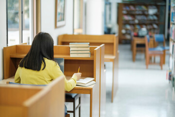 Student sitting and studying at library.