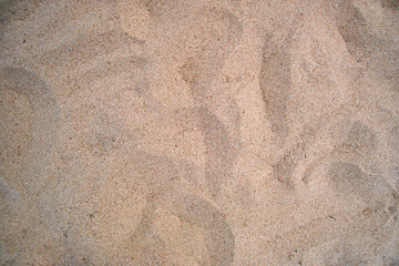 Flat view of clean yellow sand surface covering seaside beach. Sandy texture