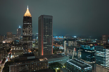 Night urban landscape of downtown district of Atlanta city in Georgia, USA. Skyline with brightly illuminated high skyscraper buildings in modern american megapolis - obrazy, fototapety, plakaty