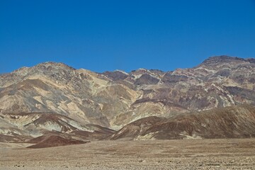 Driving along Artist's Drive, a one-way scenic loop in Death Valley, reveals rocks with a...