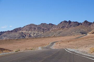 Driving along Artist's Drive, a one-way scenic loop in Death Valley, reveals rocks with a...