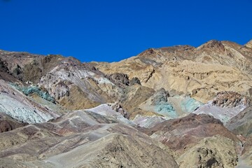 Driving along Artist's Drive, a one-way scenic loop in Death Valley, reveals rocks with a surprising number of colors. It is home to Artist's Pallette, which has a dusting of green and pink colors.