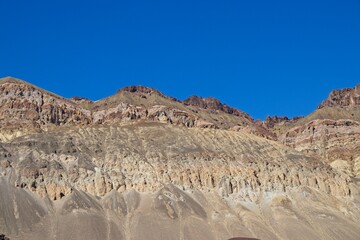 Driving along Artist's Drive, a one-way scenic loop in Death Valley, reveals rocks with a surprising number of colors. It is home to Artist's Pallette, which has a dusting of green and pink colors.