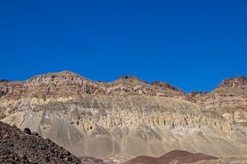 Driving along Artist's Drive, a one-way scenic loop in Death Valley, reveals rocks with a...
