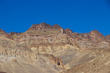 Driving along Artist's Drive, a one-way scenic loop in Death Valley, reveals rocks with a surprising number of colors. It is home to Artist's Pallette, which has a dusting of green and pink colors.