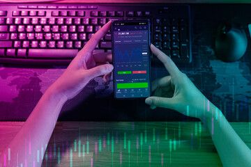 Hand holding smartphone for analyze. Online investment concept. Trader investor broker holding...